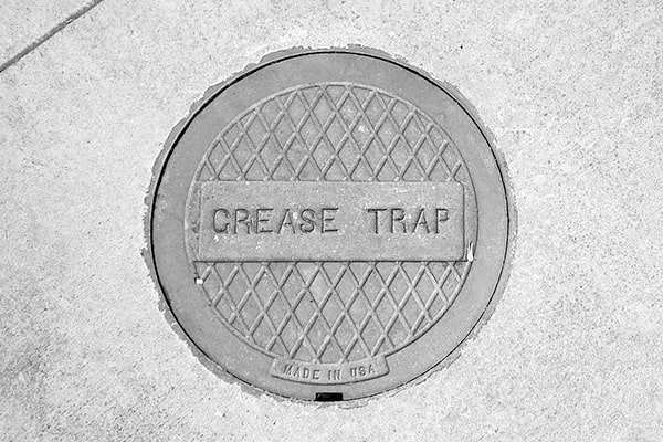 grease trap pumping is the process of removing accumulated grease and other waste from the trap to prevent clogs and backups in the plumbing system